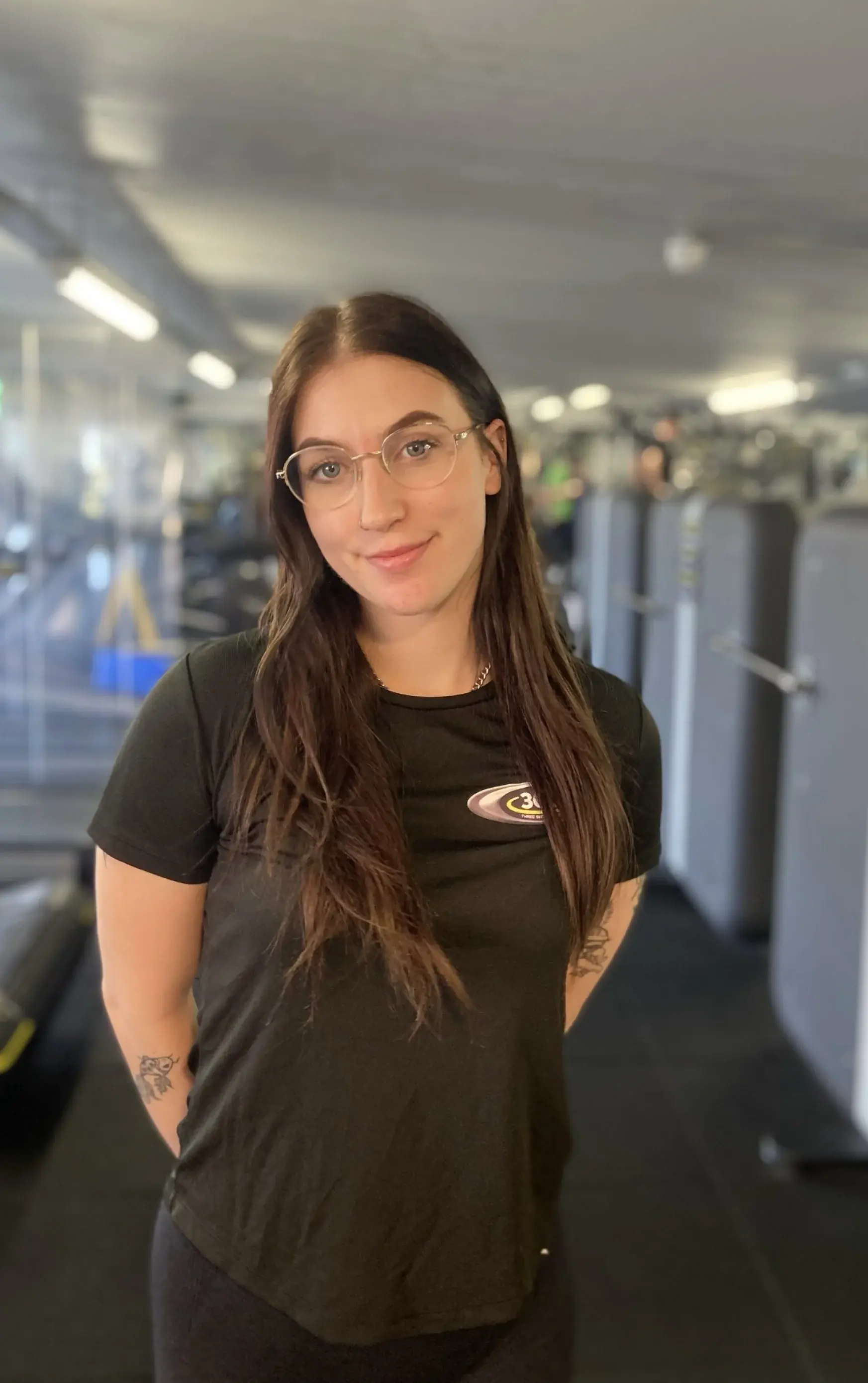 A personal trainer in a Three Sixty Fitness top
